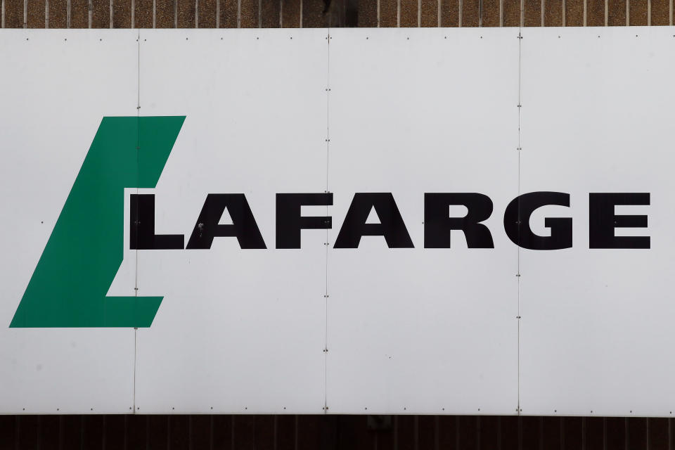 FILE - A logo of Lafarge, the world's largest cement maker, is pictured outside of a facility, in Paris, Sept. 8, 2017. Lafarge has pleaded guilty to paying $17 million to the Islamic State group so that a plant in Syria could remain open, in a case the Justice Department describes as the first of its kind. The charges were announced Tuesday in federal court in New York City. The allegations involve conduct that was earlier investigated by authorities in France. (AP Photo/Francois Mori, File)