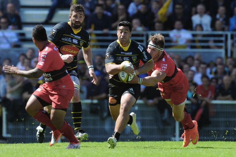 La Rochelle's Australian centre Malietoa Hingano (centre) is tackled during the French Top 14 rugby union match against Toulon at the Marcel Deflandre stadium in La Rochelle, western France on April 25, 2015