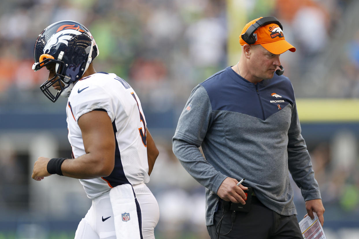 SEATTLE, WASHINGTON - SEPTEMBER 12: Russell Wilson #3 and head coach Nathaniel Hackett of the Denver Broncos pass each other during the first quarter against the Seattle Seahawks at Lumen Field on September 12, 2022 in Seattle, Washington. (Photo by Steph Chambers/Getty Images)