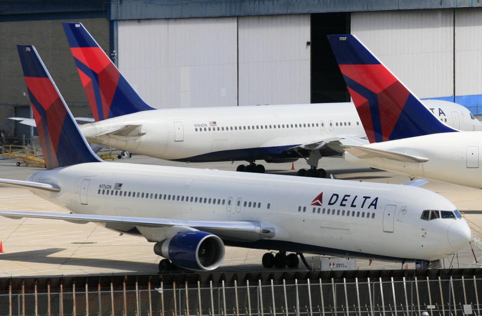 FILE - In this April 20, 2010 file photo, Delta Air Lines jets are parked at John F. Kennedy International Airport, in New York. U.S. Customs and Border Protection will issue a new policy directive under a settlement agreement that states airline passengers are not required to consent to document checks. The settlement comes in a lawsuit filed by passengers aboard a Delta flight from San Francisco to New York’s Kennedy Airport in February 2017 who were met by CBP officers and forced to hand over identification as they deplaned. It was just a few weeks after President Donald Trump’s first travel ban. (AP Photo/Mark Lennihan)