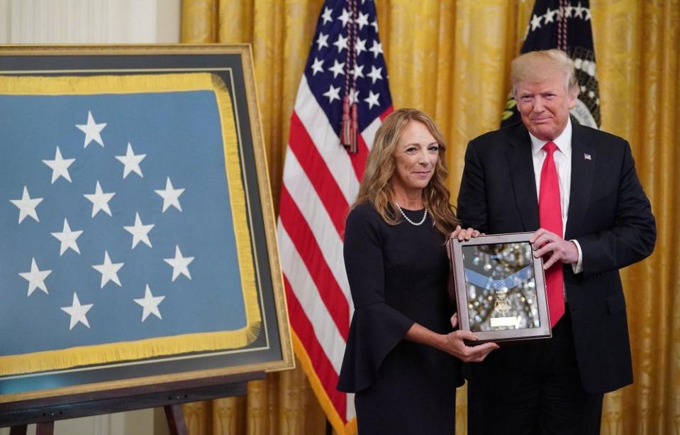 President Donald Trump presents Valerie Nessel, the widow of Air Force Tech Sgt. John Chapman, with his Medal of Honor