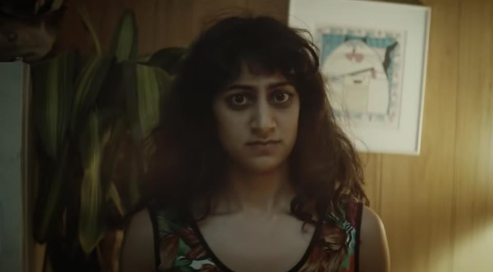 Sunita Mani stands in an apartment in the music video for Turn Down For What