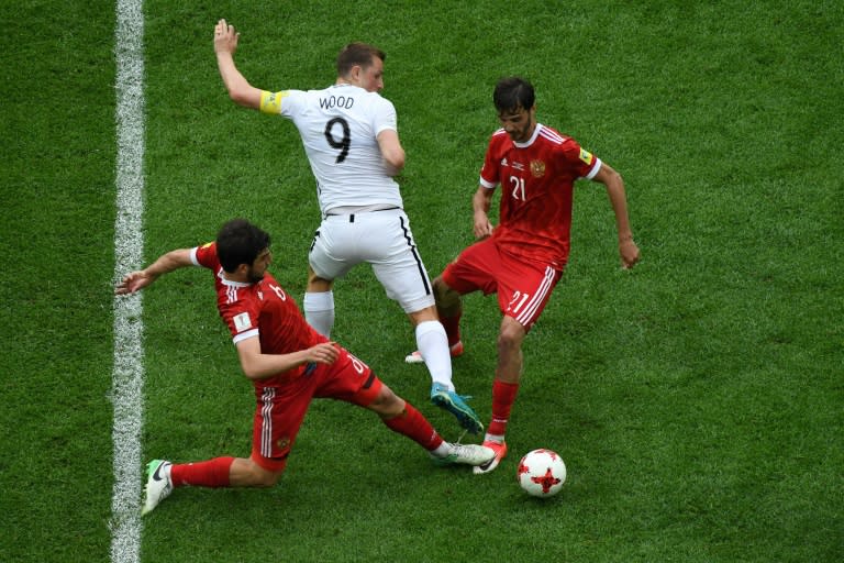 New Zealand's forward Chris Wood (C) is tackled by Russia's defender Georgiy Dzhikiya (L) and Russia's midfielder Alexander Erokhin (R) during the 2017 Confederations Cup group A football match June 17, 2017