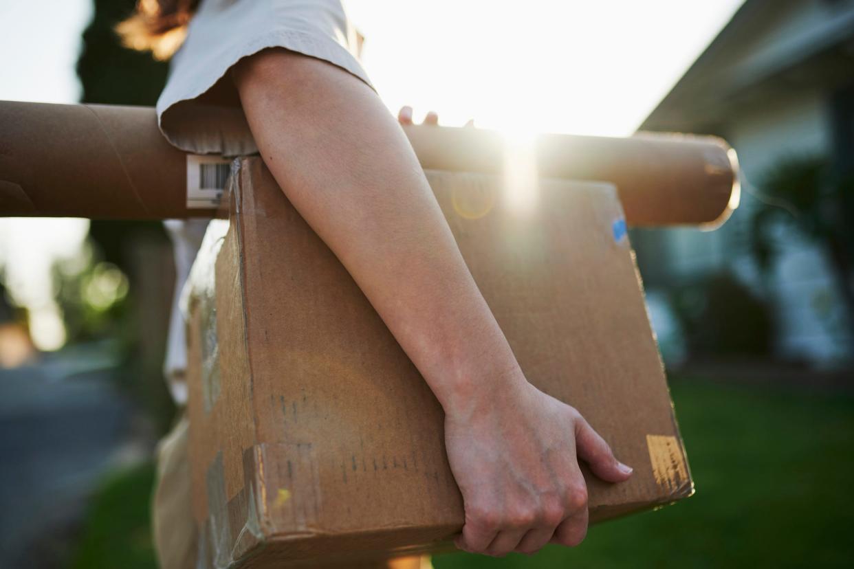 A stock image shows somebody delivering mail.