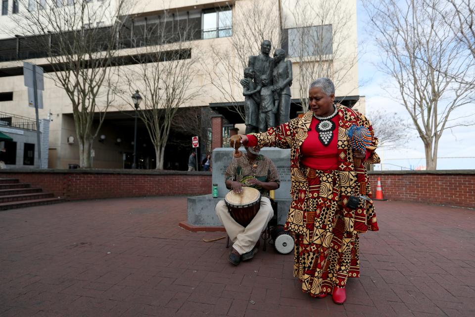 Lillian Grant-Baptiste pours water out in honor of "those who came before" during the opening libation ceremony for the 35th annual Savannah Black Heritage Festival on Saturday, February 3, 2024 on River Street.