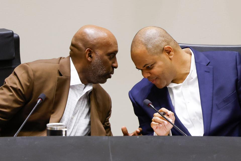 Dallas City Manager T.C. Broadnax, left, and Dallas Mayor Eric Johnson confer during a Dallas City Council meeting last fall. Tensions between Broadnax and Johnson helped lead to Broadnax's resignation.