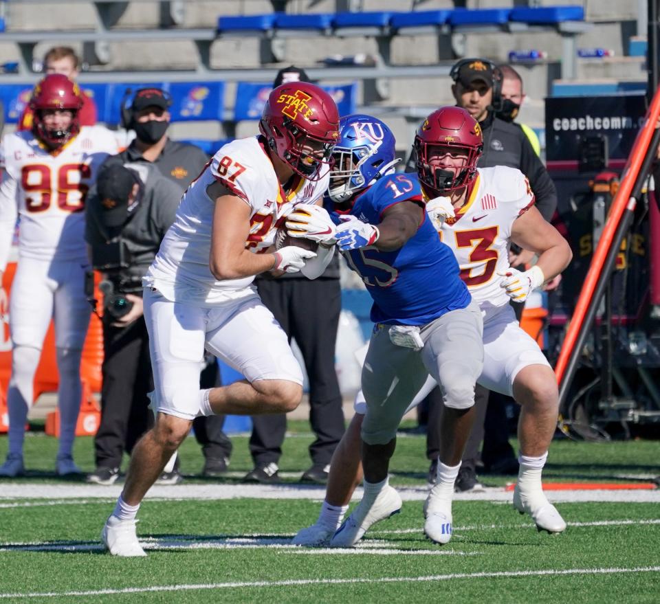 Kansas super-senior Kyron Johnson (15) attempts to bring down Iowa State receiver Ryan Pritchard in a game last season at David Booth Kansas Memorial Stadium. Johnson is switching from linebacker to defensive end this season for the Jayhawks.