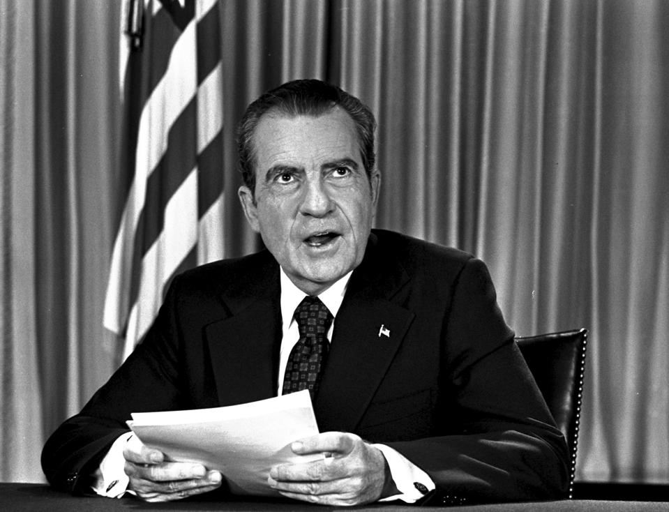 FILE - President Richard Nixon sits in his White House office, Aug. 16, 1973, as he poses for pictures after delivering a nationwide television address dealing with Watergate. In 1974, Richard Nixon faced possible charges for a wide range of alleged wrongdoing, from bribery to obstruction of justice, when Gerald Ford pardoned him just weeks after he resigned. (AP Photo, File)