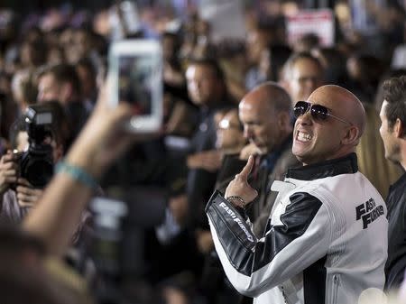 Cast member Vin Diesel poses for fans at the premiere of "Furious 7" at the TCL Chinese theatre in Hollywood, California April 1, 2015. The movie opens in the U.S. on April 3. REUTERS/Mario Anzuoni