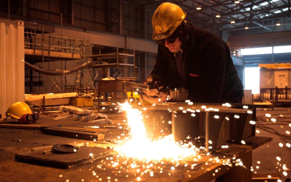 A welder works on a Queen Elizabeth Class aircraft carrier at BAE Systems Govan yard in Glasgow -  Reuters