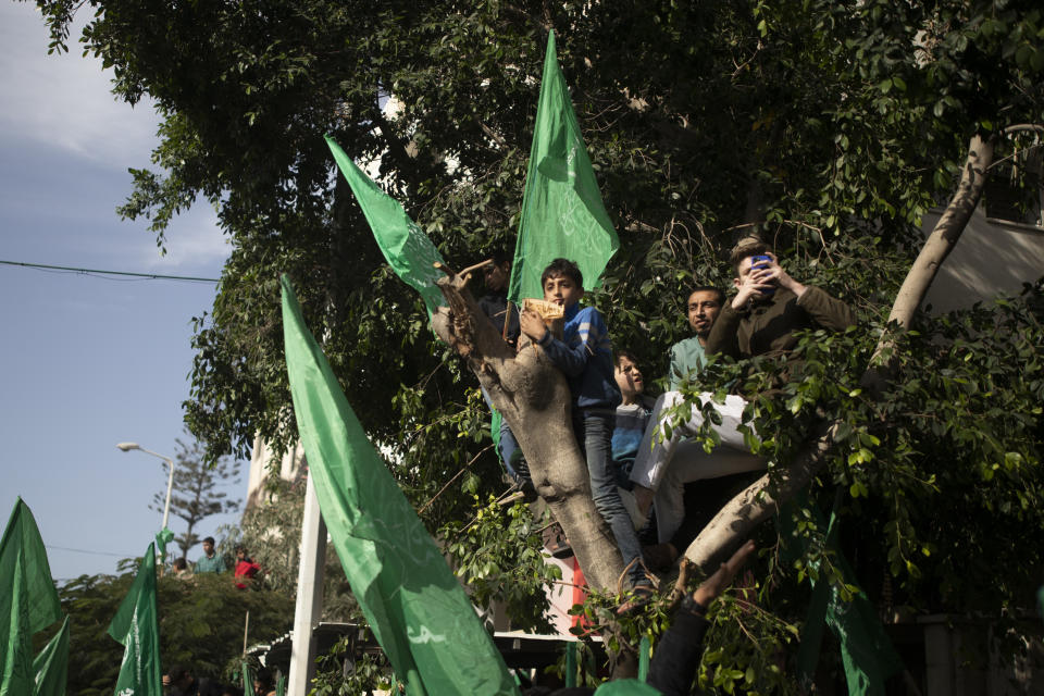 Palestinians attend a rally marking the 34th anniversary of Hamas movement's founding, in Gaza City, Friday, Dec. 10, 2021. Gaza’s Hamas rulers collect millions of dollars a month in taxes and customs at a crossing on the Egyptian border – providing a valuable source of income that helps it sustain a government and powerful armed wing. After surviving four wars and a nearly 15-year blockade, Hamas has become more resilient and Israel has been forced to accept that its sworn enemy is here to stay. (AP Photo/ Khalil Hamra)