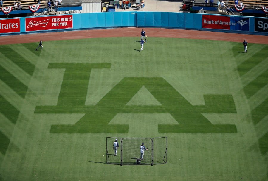 Members of the San Diego Padres warm up in the outfield before the start of an opening day baseball game against the Los Angeles Dodgers, Monday, April 3, 2017, in Los Angeles. (AP Photo/Ryan Kang)