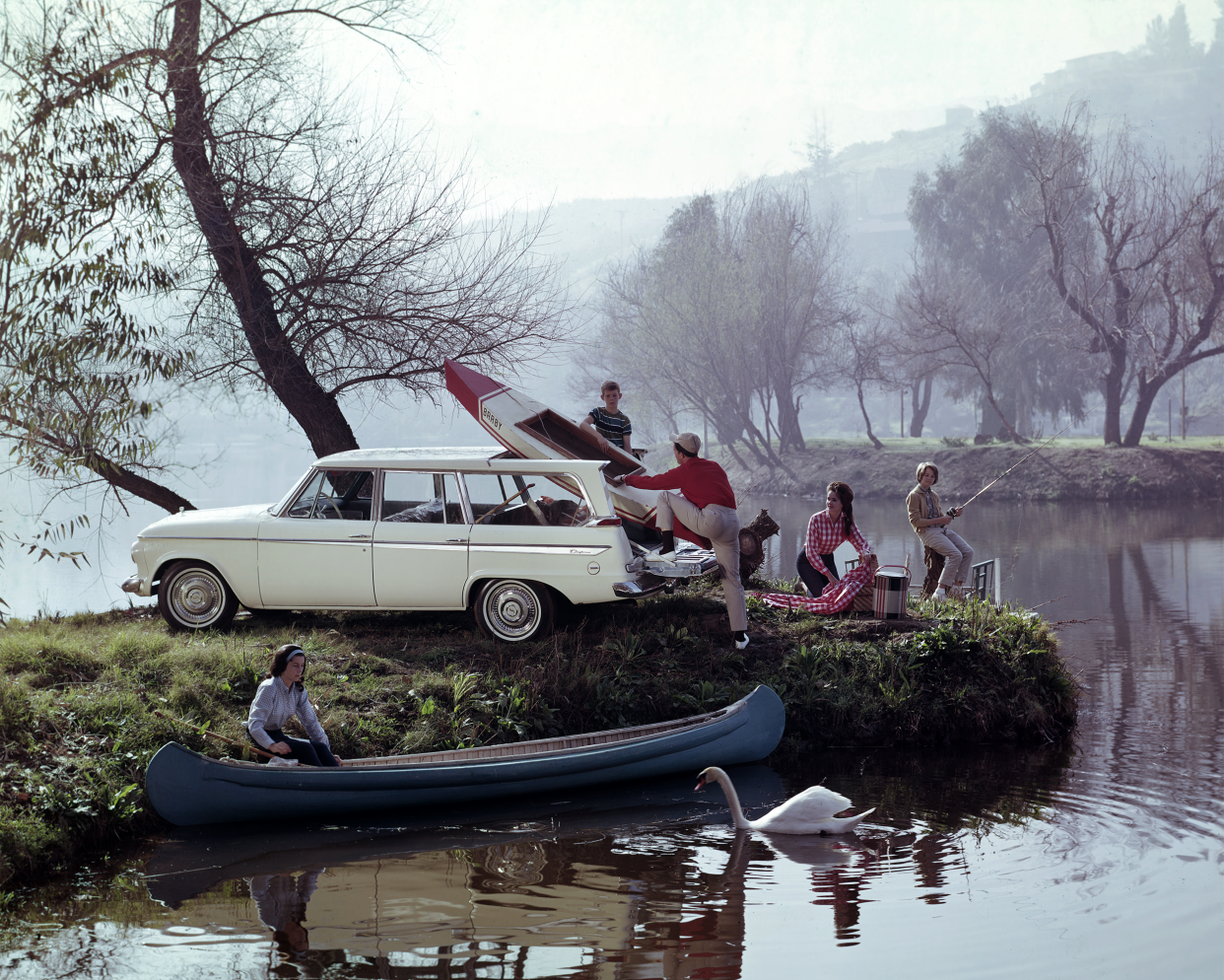 A family enjoys a day out on the lake and unpacks their gear in this advertisement for the 1962 Studebaker Lark Daytona Wagonaire, Santa Barbara, CA, 1962.