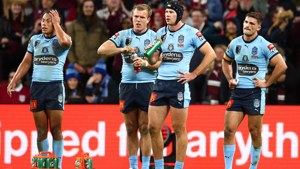 NSW Blues players huddle together after Queensland scored a try in State of Origin III.