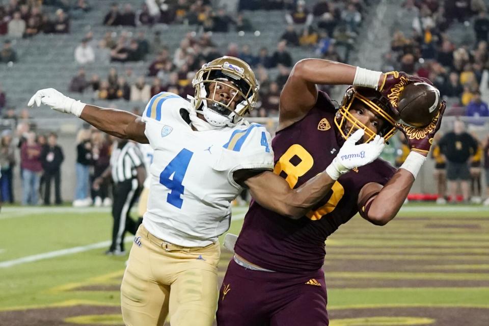 Arizona State tight end Messiah Swinson makes a catch against UCLA defensive back Stephan Blaylock.