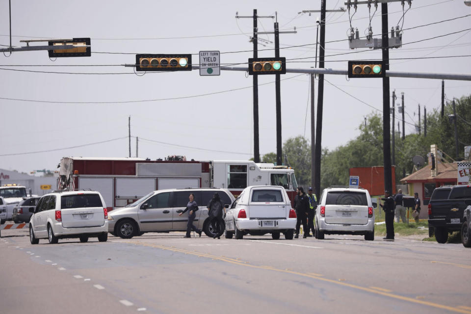 Emergency personnel respond to a fatal collision in Brownsville, Texas, on Sunday, May 7, 2023. Several migrants were killed after they were struck by a vehicle while waiting at a bus stop near Ozanam Center, a migrant and homeless shelter. (AP Photo/Michael Gonzalez)