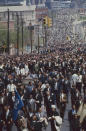 <p>A funeral procession of 1,300 people walks from Ebenezer Baptist Church to Morehouse College. (Photo: Lynn Pelham/The LIFE Picture Collection/Getty Images) </p>