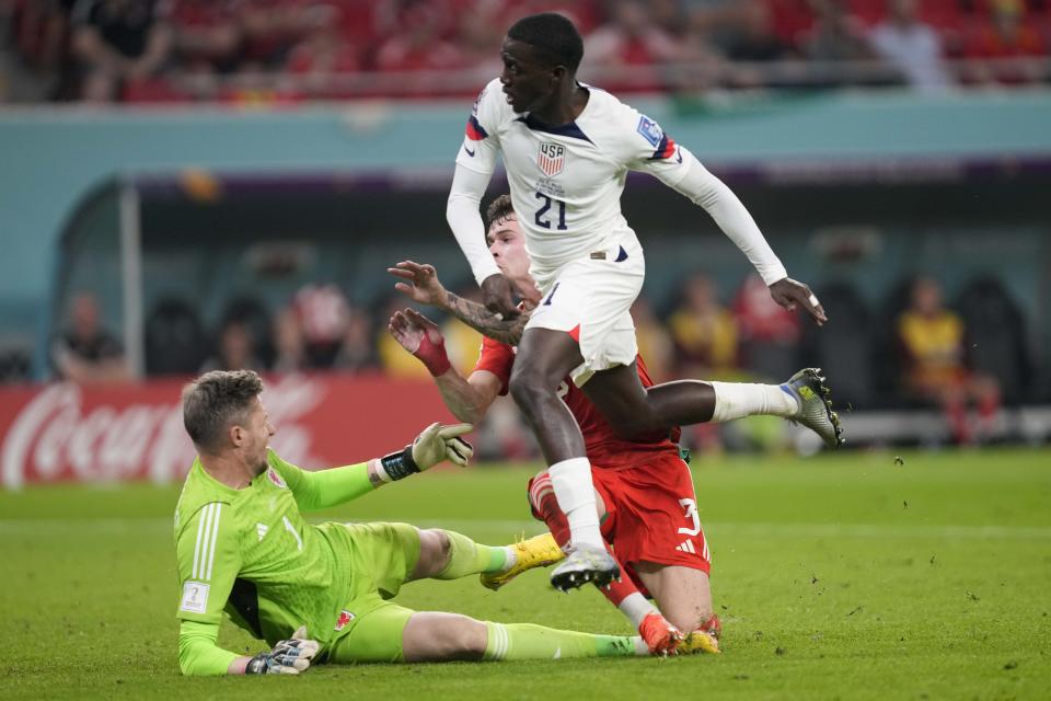 Tim Weah of the United States scores during the World Cup, group B football match between the United States and Wales, at the Ahmad Bin Ali Stadium in in Doha, Qatar, Monday, Nov. 21, 2022. (AP Photo/Darko Vojinovic)