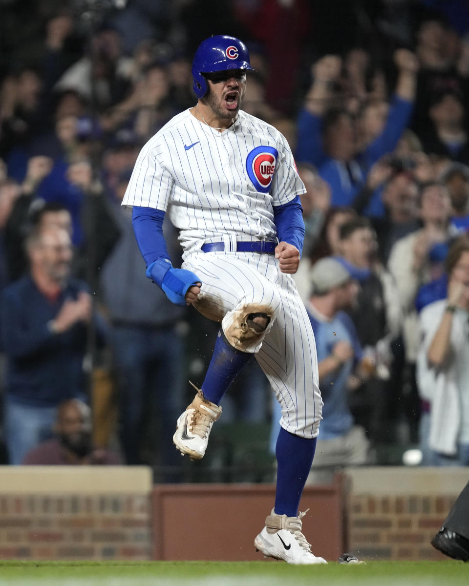 Chicago Cubs' Mike Tauchman reacts after scoring on a two-run single by Ian Happ off Pittsburgh Pirates relief pitcher Yohan Ramirez during the sixth inning of a baseball game Wednesday, June 14, 2023, in Chicago. (AP Photo/Charles Rex Arbogast)