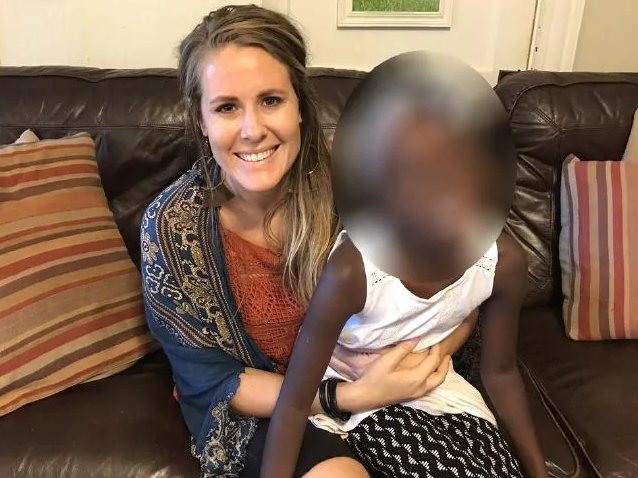 Renee Bach with a child on her lap. Ms Bach, who works for Serving His Children, is accused of providing medical care to children in Uganda despite having no qualifications. A lawsuit claims she's responsible for the deaths of 100 kids.