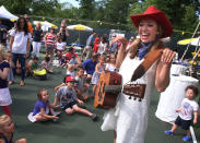 <p>Miss Jamie of Miss Jamie’s Farm entertains children at a concert during a Fourth of July celebration Monday, July 3, 2017, at Spring Lake Park in Lincolnshire, Ill. (Photo: Gilbert R. Boucher II/Daily Herald via AP) </p>