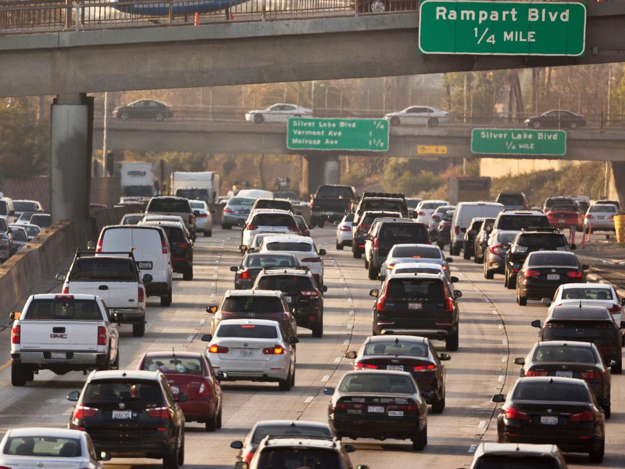 FILE - In this Dec. 12, 2018, file photo, traffic moves on the Hollywood Freeway in Los Angeles. Nearly two dozen states and several cities are challenging the Trump administration's rollback of Obama-era mileage standards, saying science backed up the old regulations developed with the help of the nation's car makers. They asked the U.S. Court of Appeals for the District of Columbia Circuit on Wednesday, May 27, 2020, to review the actions of government agencies that led to the new rule being issued in March. (AP Photo/Damian Dovarganes, File)