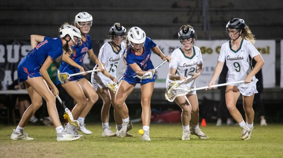Catholic and Bolles High Schools battle for possession of a loose lacrosse ball during the District 1-A girls' lacrosse semi-final match on Friday, April 21, 2023. 