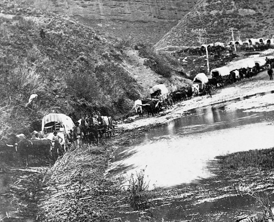 A covered wagon caravan of Mormon emigrants trying to cross a river in 1879. <a href="https://www.gettyimages.com/detail/news-photo/covered-wagon-caravan-of-mormon-emigrants-trying-to-cross-a-news-photo/615306872?adppopup=true" rel="nofollow noopener" target="_blank" data-ylk="slk:Corbis Historical via Getty Images;elm:context_link;itc:0;sec:content-canvas" class="link ">Corbis Historical via Getty Images</a>