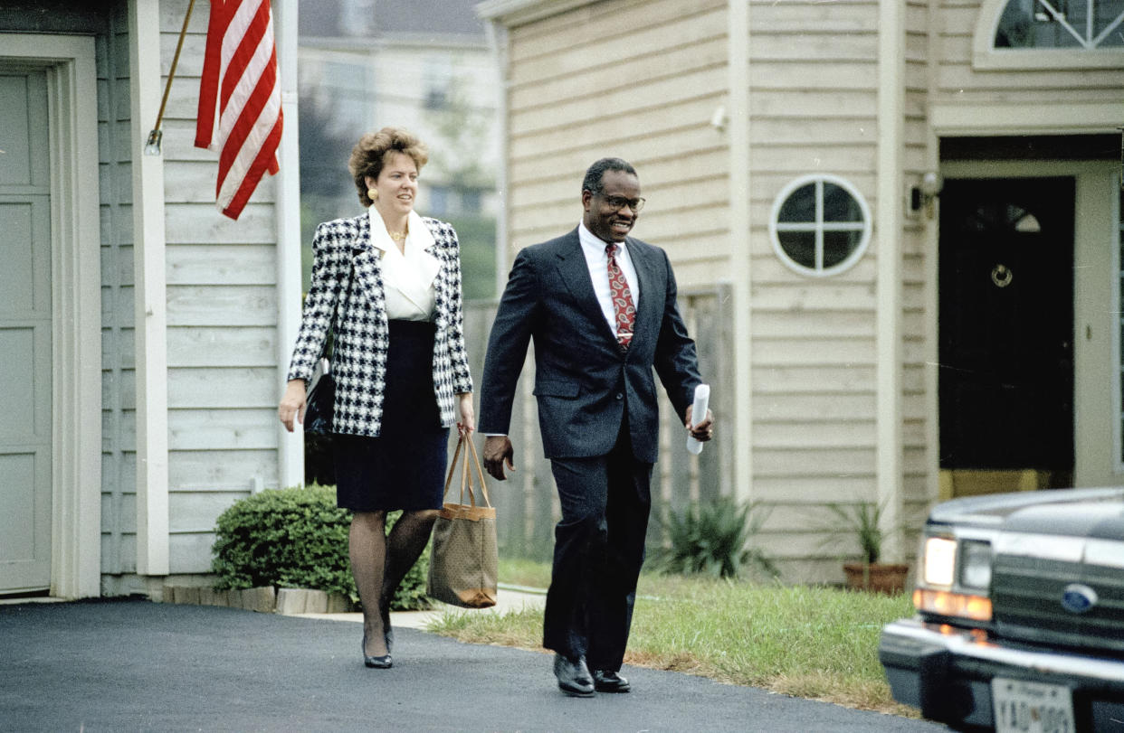 Supreme Court nominee Clarence Thomas leaves his Alexandria, Va., home, Oct. 11, 1991, with his wife Virginia. (Barry Thumma / AP file)