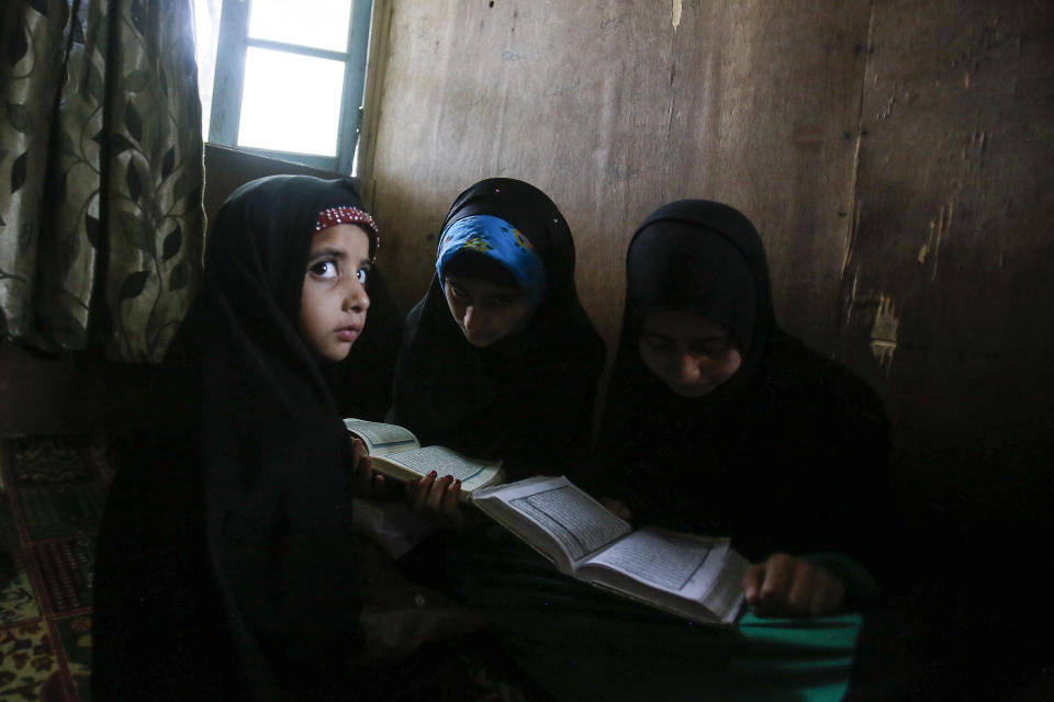 Kashmiri Muslim children attend recitation classes of the holy Quran on the first day of the fasting month of Ramadan in Srinagar, Indian controlled Kashmir, May 7, 2019. The image was part of a series of photographs by Associated Press photographers which won the 2020 Pulitzer Prize for Feature Photography. (AP Photo/Mukhtar Khan)