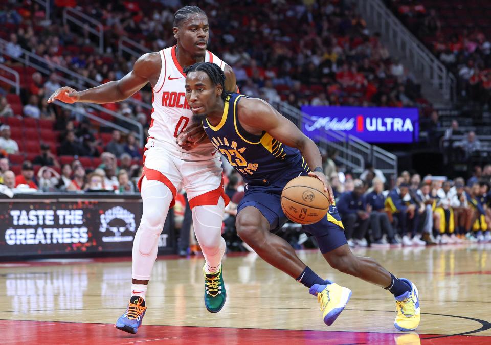 Oct 10, 2023; Houston, Texas, USA; Indiana Pacers forward Aaron Nesmith (23) drives with the ball as Houston Rockets guard Aaron Holiday (0) defends during the third quarter at Toyota Center. Mandatory Credit: Troy Taormina-USA TODAY Sports