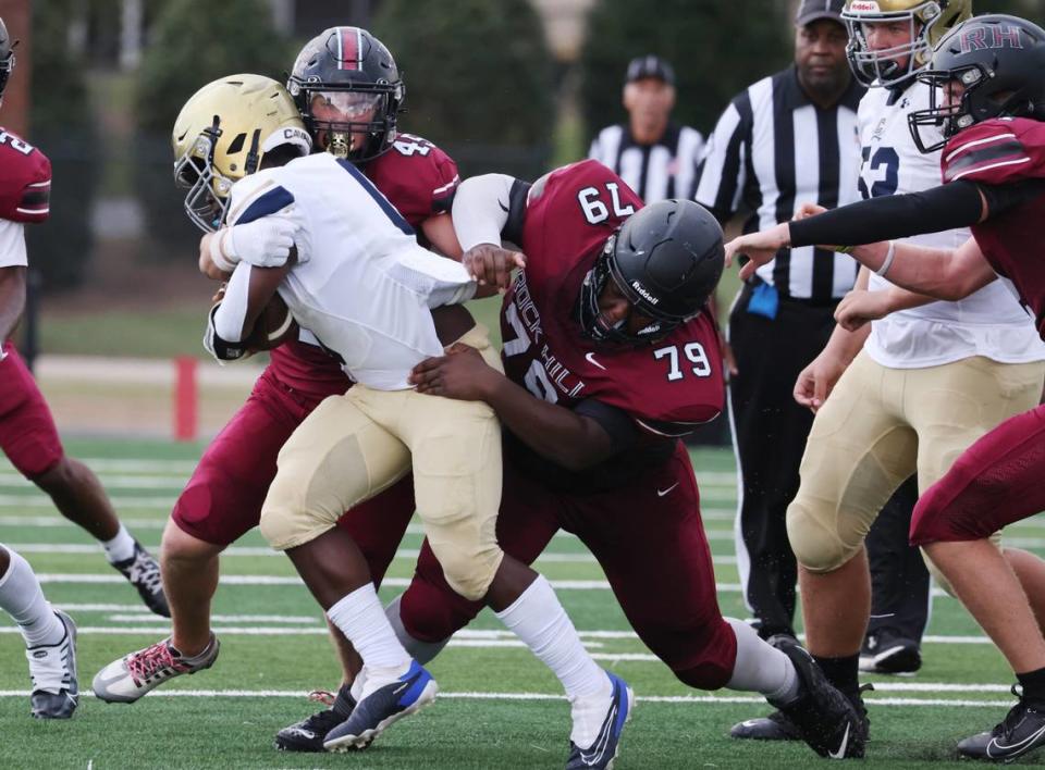 Rock Hill’s Landon Armstrong (45) and Charles Burrell (79) bring down a Cuthbertson a Cuthbertson player Friday, Aug. 11, 2023 in Rock Hill, S.C.