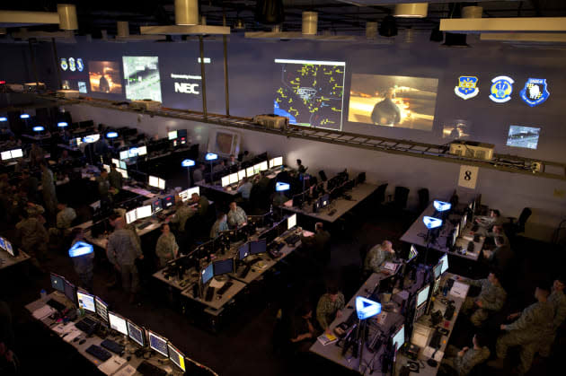 Airmen participate in the live, virtual, constructive portion of Red Flag 15-2 at the Combined Operations Center-Nellis on Nellis Air Force Base, Nev., Mar. 5, 2015. Red Flag 15-2 will be the first Red Flag exercise that will include hundreds of virtual and constructive participants in simulators at their home stations or the Distributed Mission Operations Center at Kirtland AFB, N.M. (U.S. Air Force photo by Senior Airman Thomas Spangler)