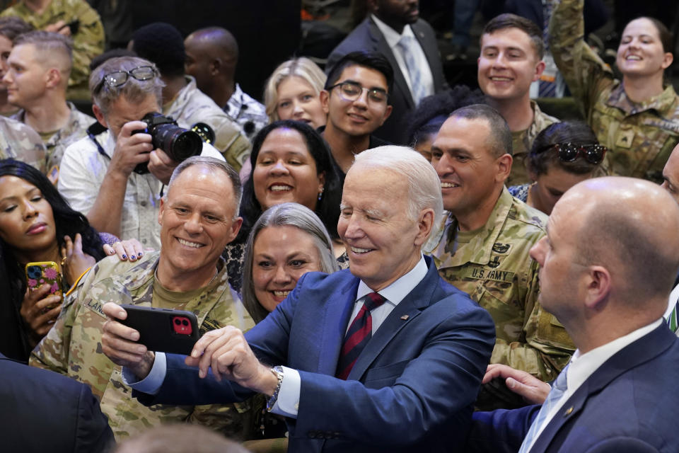 President Joe Biden takes a selfie during a visit to Fort Liberty, N.C., Friday, June 9, 2023. (AP Photo/Susan Walsh)