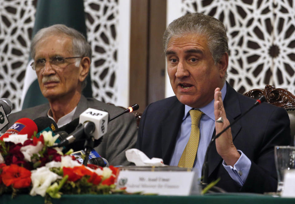 Pakistani Foreign Minister Shah Mahmood Qureshi, right, gives a press conference with Defense Minister Pervez Khattak after an Indian airstrike, in Islamabad, Pakistan, Tuesday, Feb. 26, 2019. Pakistan said India launched an airstrike on its territory early Tuesday that caused no casualties, while India said it targeted a terrorist training camp in a pre-emptive strike that killed a "very large number" of militants. (AP Photo/Anjum Naveed)