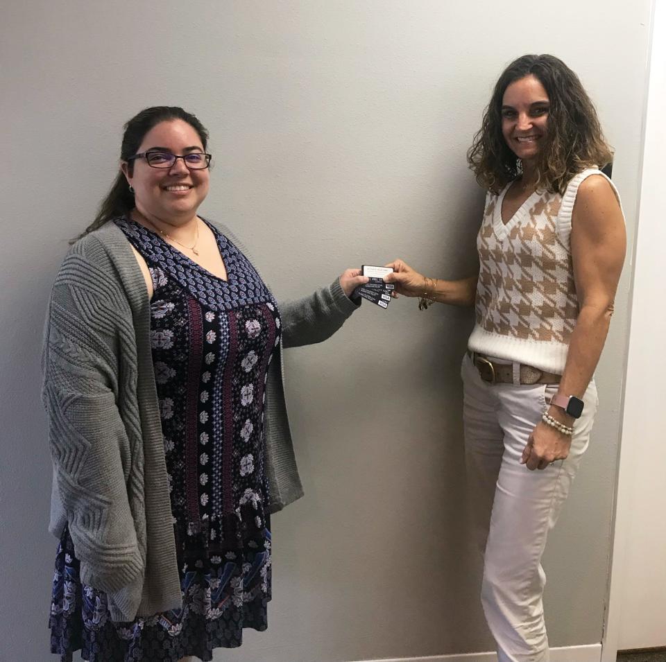Isabella Batalla and Tonia Hutchinson, of Safe Children Coalition, with gift cards purchased through a grant from Gulf Coast Community Foundation.