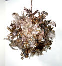 This undated photo provided by Elizabeth Lyons shows Lyon’s glass chandelier from Elizabethlyons.com where she used leaf and blossom imagery to create a unique lighting piece. (AP Photo/Elizabeth Lyons)