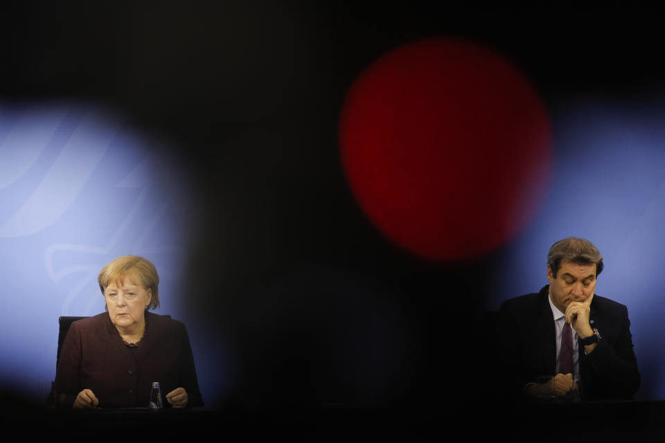 FILE - In this file photo dated Wednesday, Feb. 10, 2021, German Chancellor Angela Merkel, left, and Bavarian state governor Markus Soeder, right, attend a news conference after a meeting at the chancellery in Berlin, Germany. The 54-year-old Soeder is fighting to win enough backing across the political spectrum in hope of succeeding Angela Merkel as chancellor of Germany in Autumn 2021. (AP Photo/Markus Schreiber, FILE)