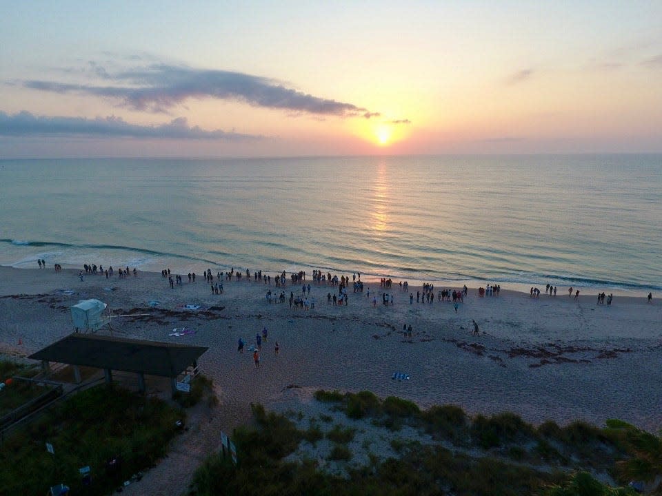 Vero Beach High School students watch the sunrise, Friday, May 10, 2024, at Humiston Beach Park before their last day of school, in this image taken from a drone.