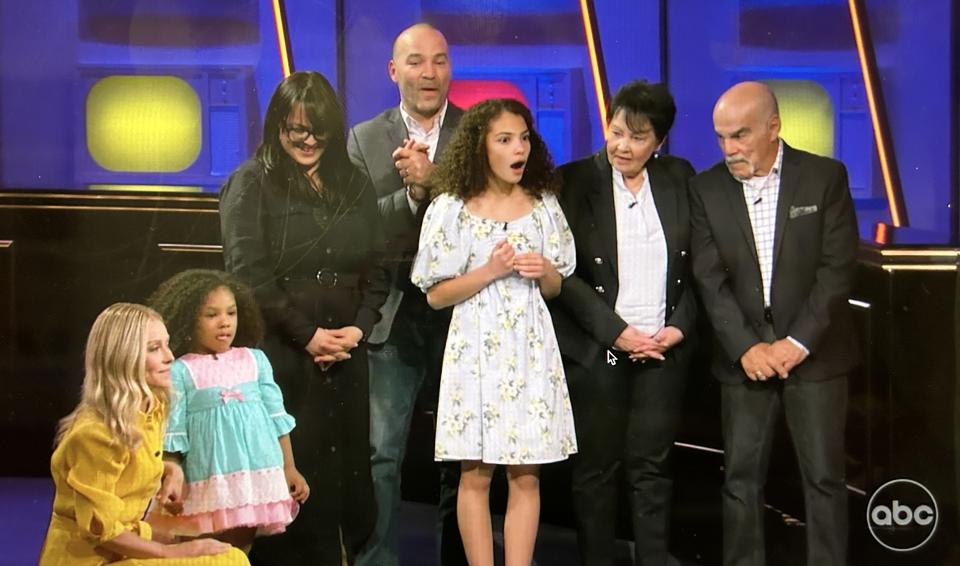 A youngster chooses between a real and a toy vehicle as her family and host Ripa await her decision.