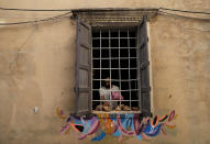 A worker washes old stones, as he reconstructs a wall of a heritage house that was damaged by Aug. 4 explosion that hit the seaport of Beirut, in Lebanon, Tuesday Aug. 25, 2020. In the streets of Beirut historic neighborhoods, workers are erecting scaffolding to support buildings that have stood for more than a century - now at risk of collapse after the massive Aug. 4 explosion that tore through the capital. (AP Photo/Hussein Malla)