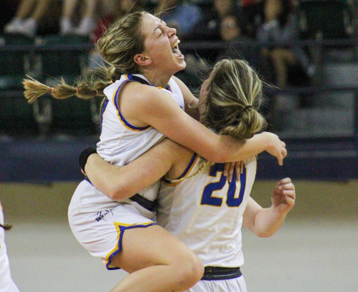 Presley Wheeler jumps into the arms of Iris Schilderink after Nazareth's 26-24 win over Claude in the Region I-1A championship girls basketball game in the Texan Dome at Levelland on Saturday, Feb. 25, 2023.