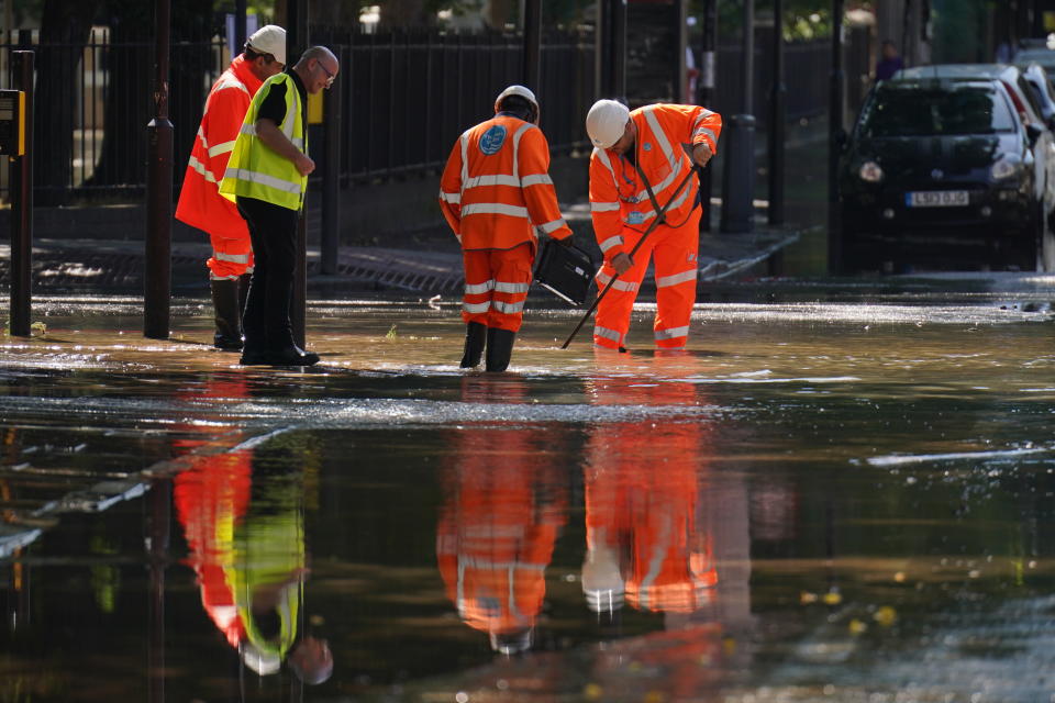 Thames Water officials work after a 36-inch water main burst, causing flooding up to four feet deep on 8 August 2022.