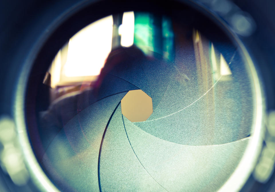 A close-up of a camera aperture opening.