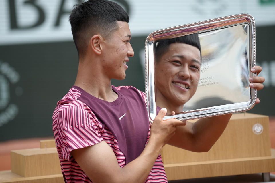 Japan's Tokito Oda holds the trophy as he celebrates after beating Britain's Alfie Hewett during the final match of the Men's Wheelchair Singles French Open tennis tournament at the Roland Garros stadium in Paris, Saturday, June 10, 2023. (AP Photo/Christophe Ena)