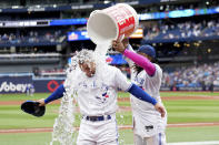 Toronto Blue Jays' George Springer (4) gets doused by teammate Vladimir Guerrero Jr. (27) after a baseball game against the Kansas City Royals, Saturday, Sept. 9, 2023, in Toronto. (Nathan Denette/The Canadian Press via AP)