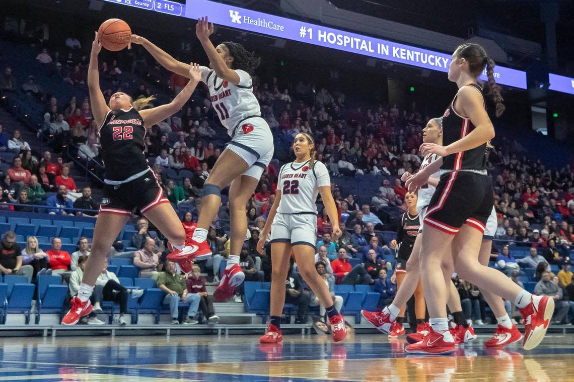 Sacred Heart’s ZaKiyah Johnson (11) blocks a shot by Lawrence County’s Leandra Curnutte (22) Wednesday’s game in Rupp Arena. The 15th Region champions kept things close early against the two-time defending state champions but ultimately faded.