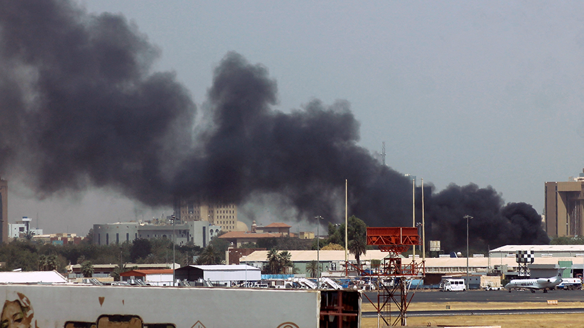 Heavy smoke bellows above buildings in the vicinity of the Khartoum airport on Saturday, amid clashes in the Sudanese capital (AFP)