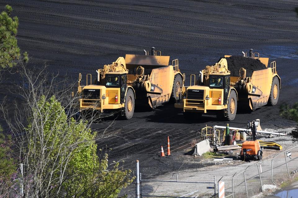 Heavy machinery moves coal at the Bull Run fossil plant on March 29.