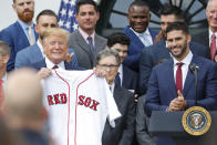 President Donald Trump, left, holds a team jersey that was presented to him by outfielder J.D. Martinez, right, during a ceremony on the South Lawn of the White House in Washington, Thursday, May 8, 2019, where Trump honored the 2018 World Series Baseball Champion Boston Red Sox. (AP Photo/Pablo Martinez Monsivais)
